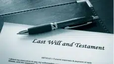 A picture of a will of a deceased person online with a pen.