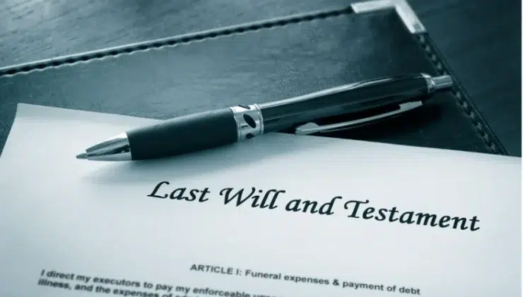 A picture of a will of a deceased person online with a pen.