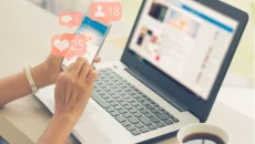 A person using tech to check social media accounts by phone number with notifications on the screen.